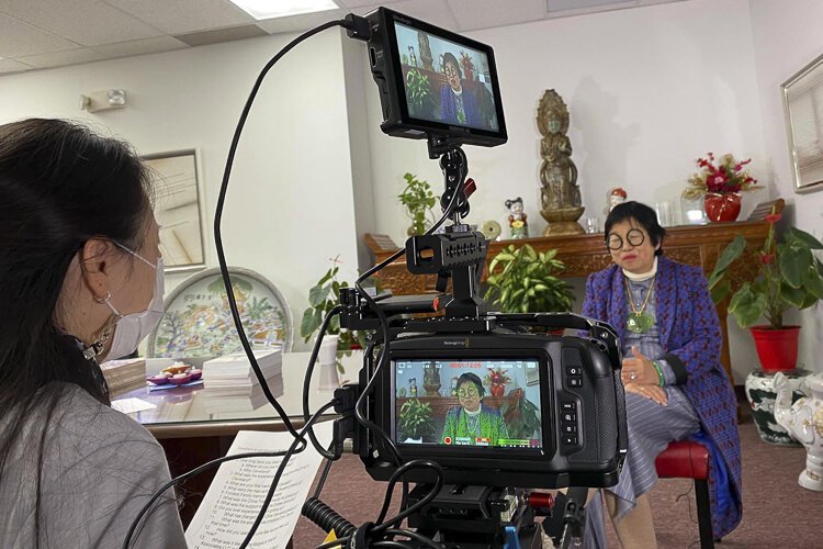 Margaret Wong being interviewed at her office